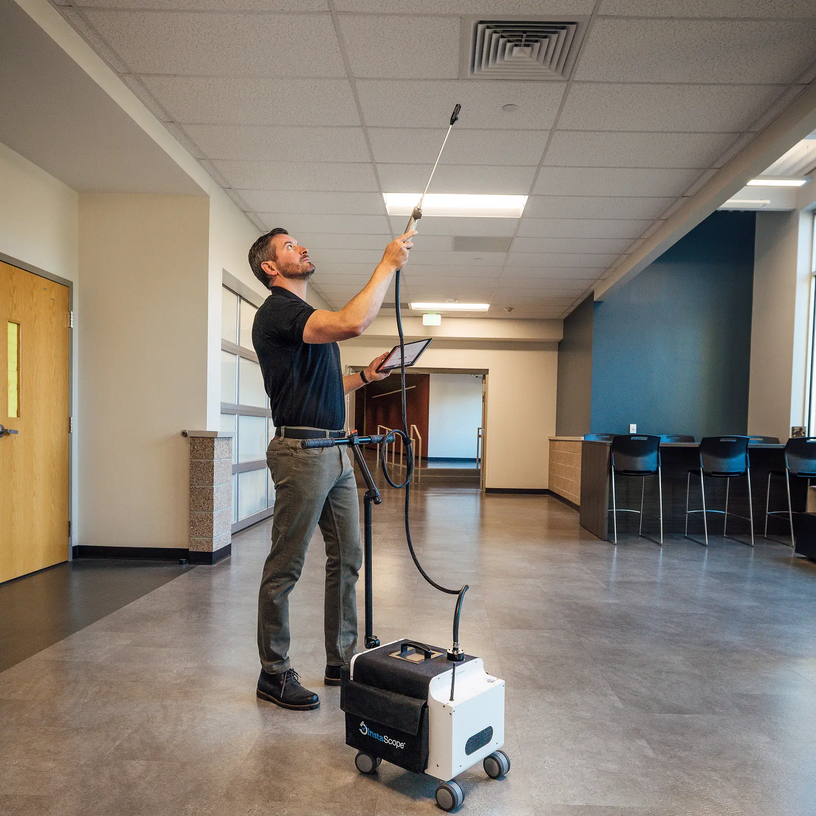 Pure Mold Masters technician scanning a ceiling vent with the InstaScope wand